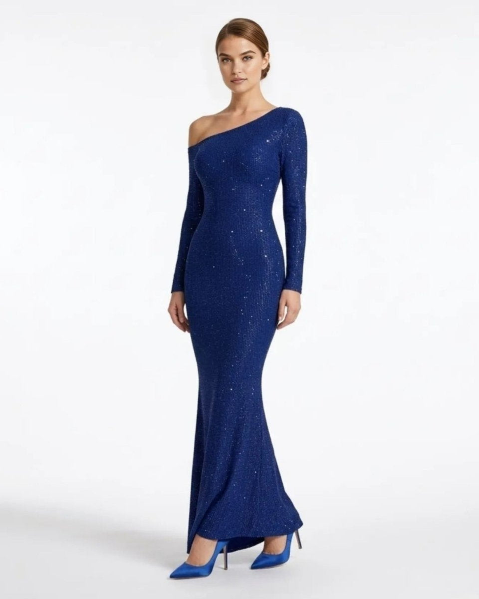 Side profile of a woman modeling an elegant wine red sparkly evening gown with asymmetric neckline. 