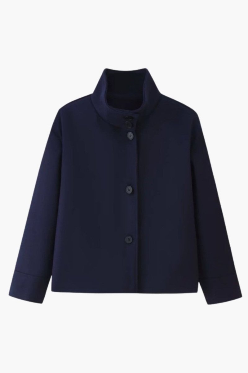 Flat lay product shot of navy single breasted button up cropped jacket with high collar.