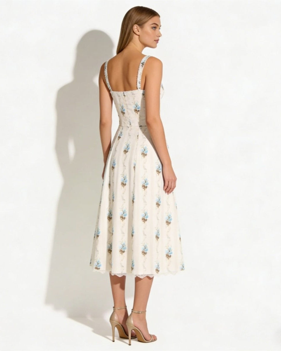 Back view of the  Nefeli cream floral corset midi dress, displaying the strap detail and tailored fit of the bodice.