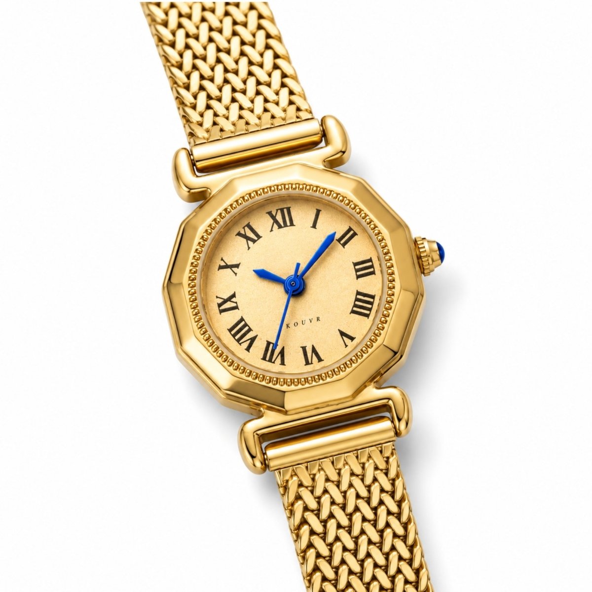 Angled close up of a women's gold luxury watch highlighting the vintage braided mesh strap and blue cabochon crown
