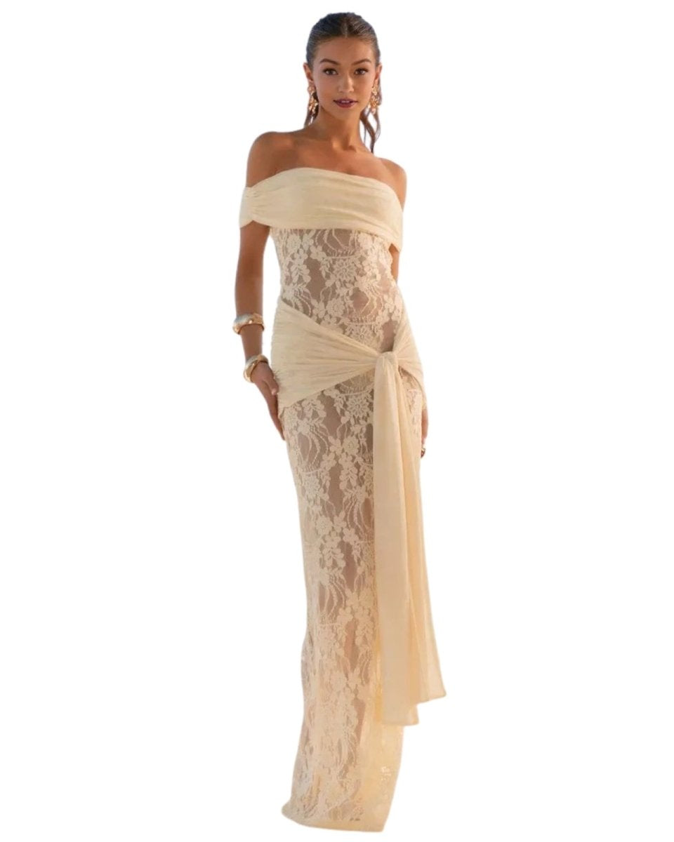 Woman wearing a yellow off-shoulder lace dress on a white background