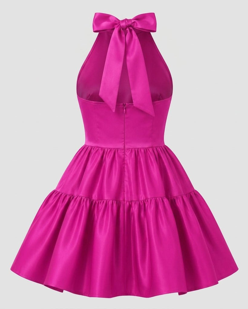 Product view highlighting the statement back bow, open back design, and concealed zipper of the pink satin cocktail dress.