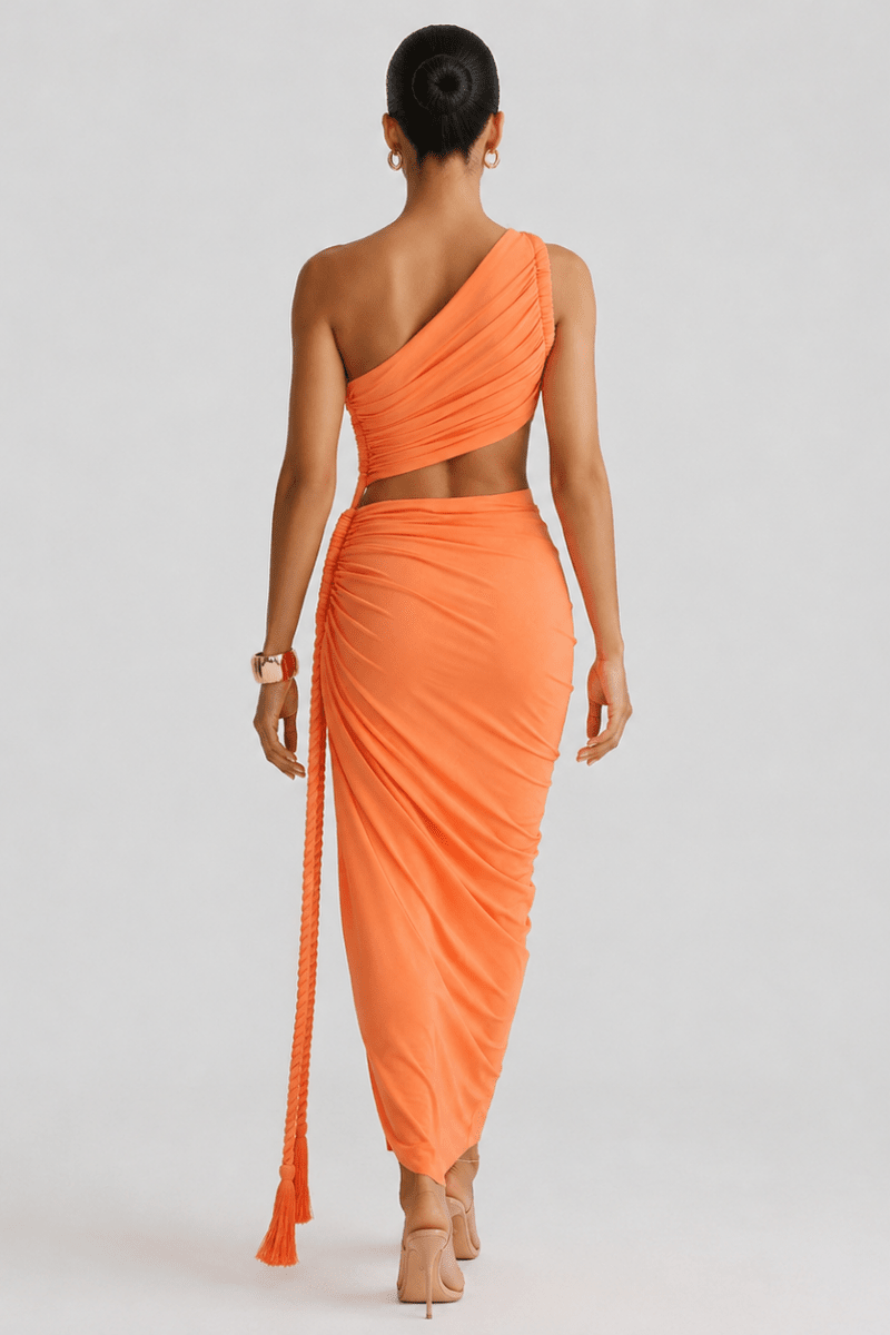 Back view of the orange asymmetrical ruched vacation dress highlighting the seamless drape, bodycon fit, and one-shoulder strap.