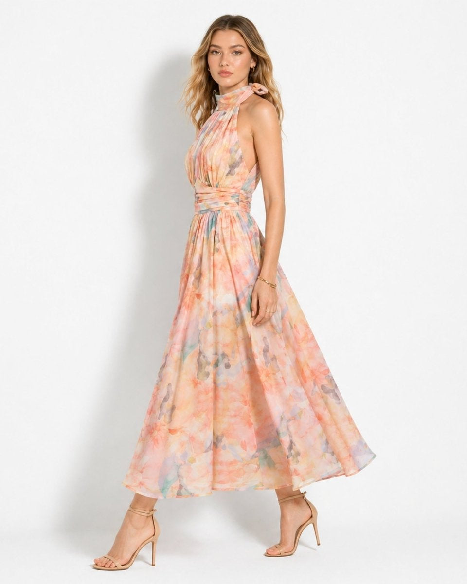 Side profile of woman walking in flowing chiffon pastel floral open back midi dress