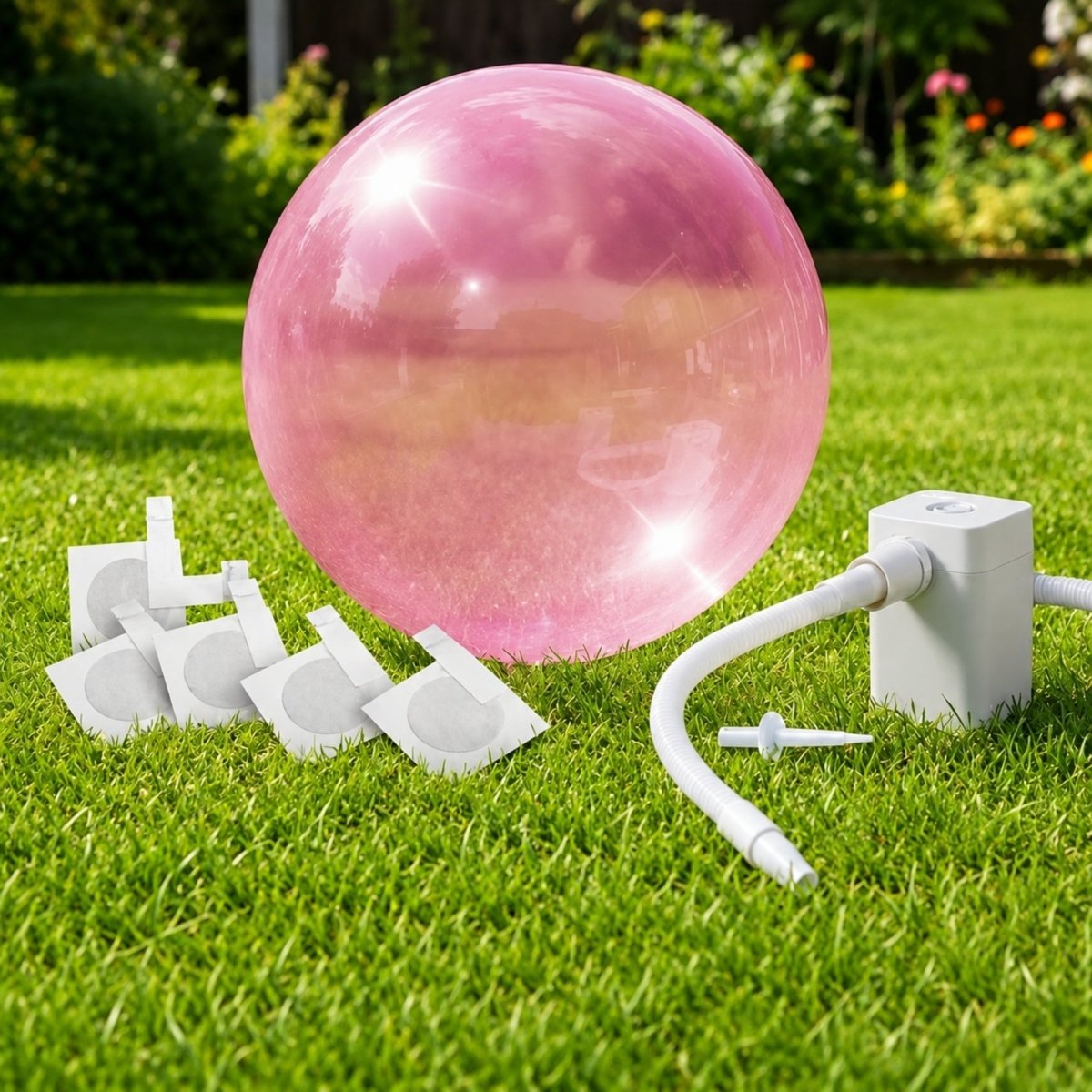 Pink giant inflatable bubble ball displayed on a lawn with a white electric pump and accessories, featuring a buy one get one free offer.