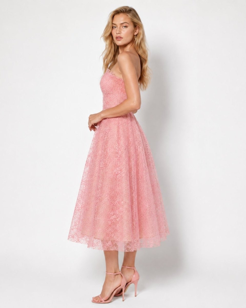 Rear view of soft pink luxury fit and flare midi gown highlighting the seamless back zipper, tailored waist, and delicate scalloped lace hem.