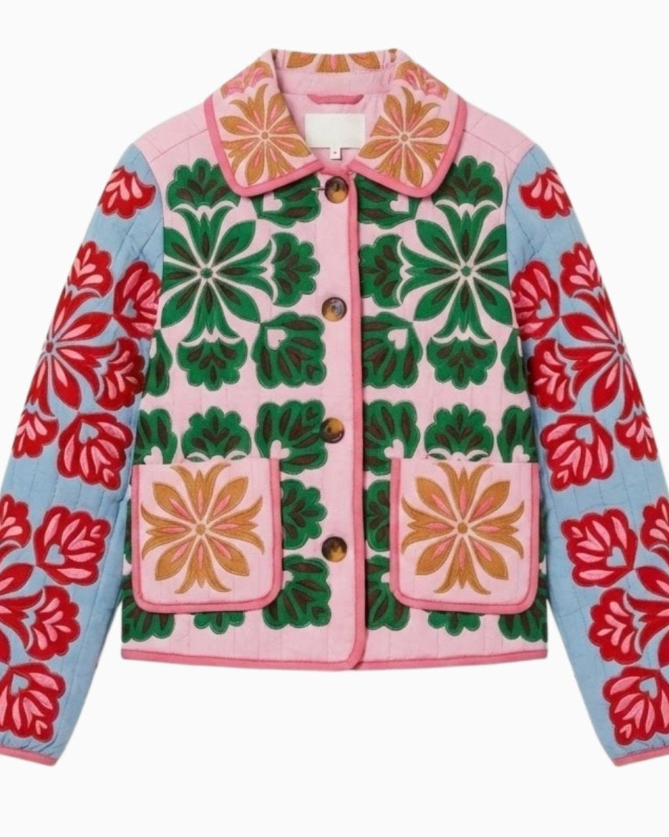 Flat lay of a pink and green quilted jacket showcasing the full floral embroidery design, collar, buttons, and patch pockets on a white background.