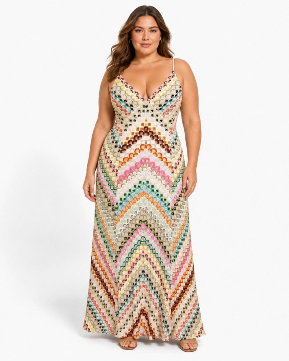 A woman modeling a sleeveless, floor-length crochet knit maxi dress with a colorful chevron pattern on a light cream background, set against a plain white studio background.