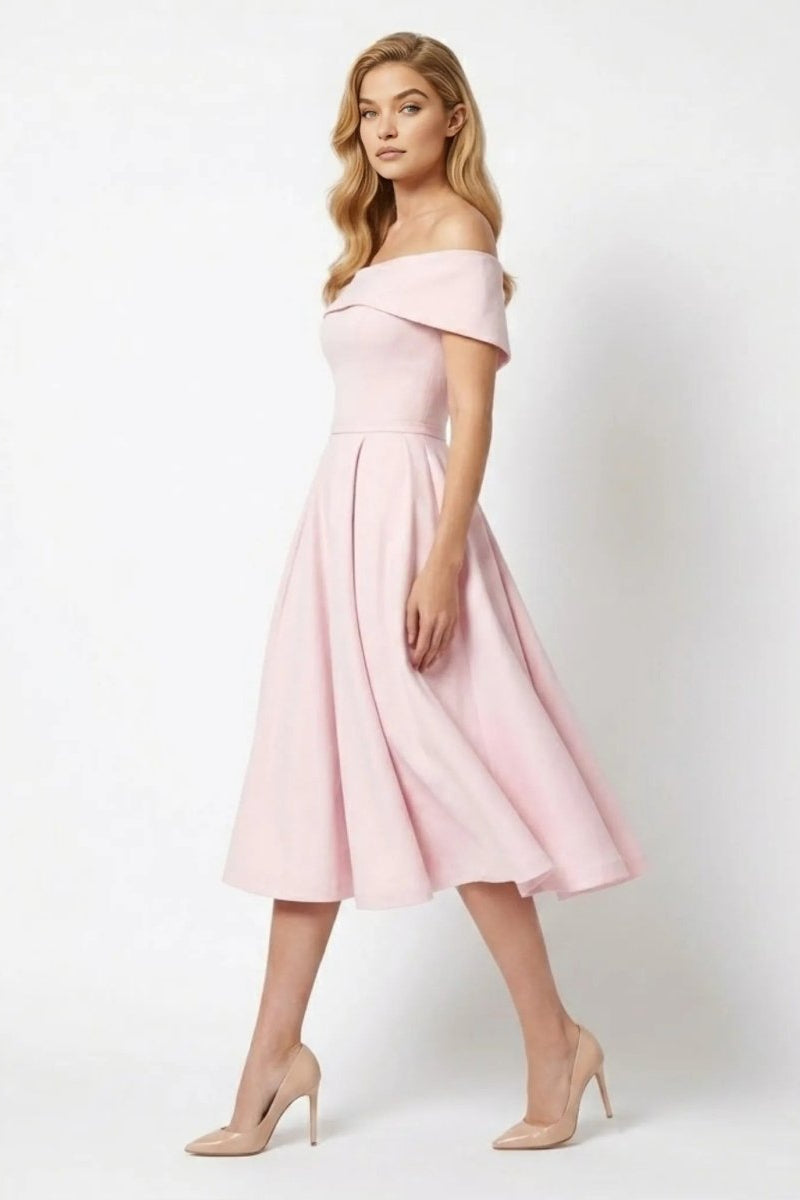 Side profile of blush pink tea length cocktail dress showing full pleated skirt