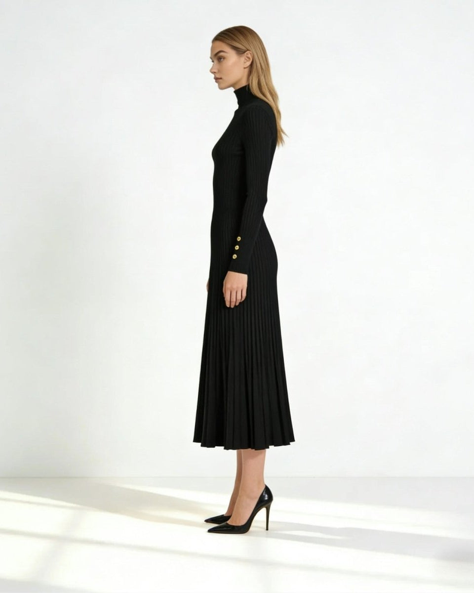 Side profile of the long sleeve black pleated midi dress highlighting the gold button cuff detail and elegant silhouette.
