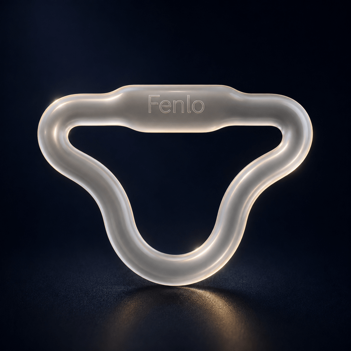 A translucent silicone baby teether or pacifier clip with the brand name 'Fenlo' debossed on the top, shown on a dark reflective surface.