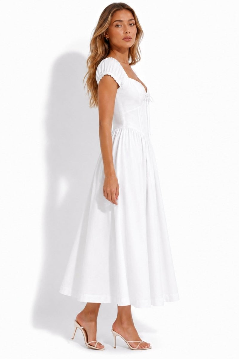 Side profile of woman in elegant white sweetheart tea dress showing flattering corset waist