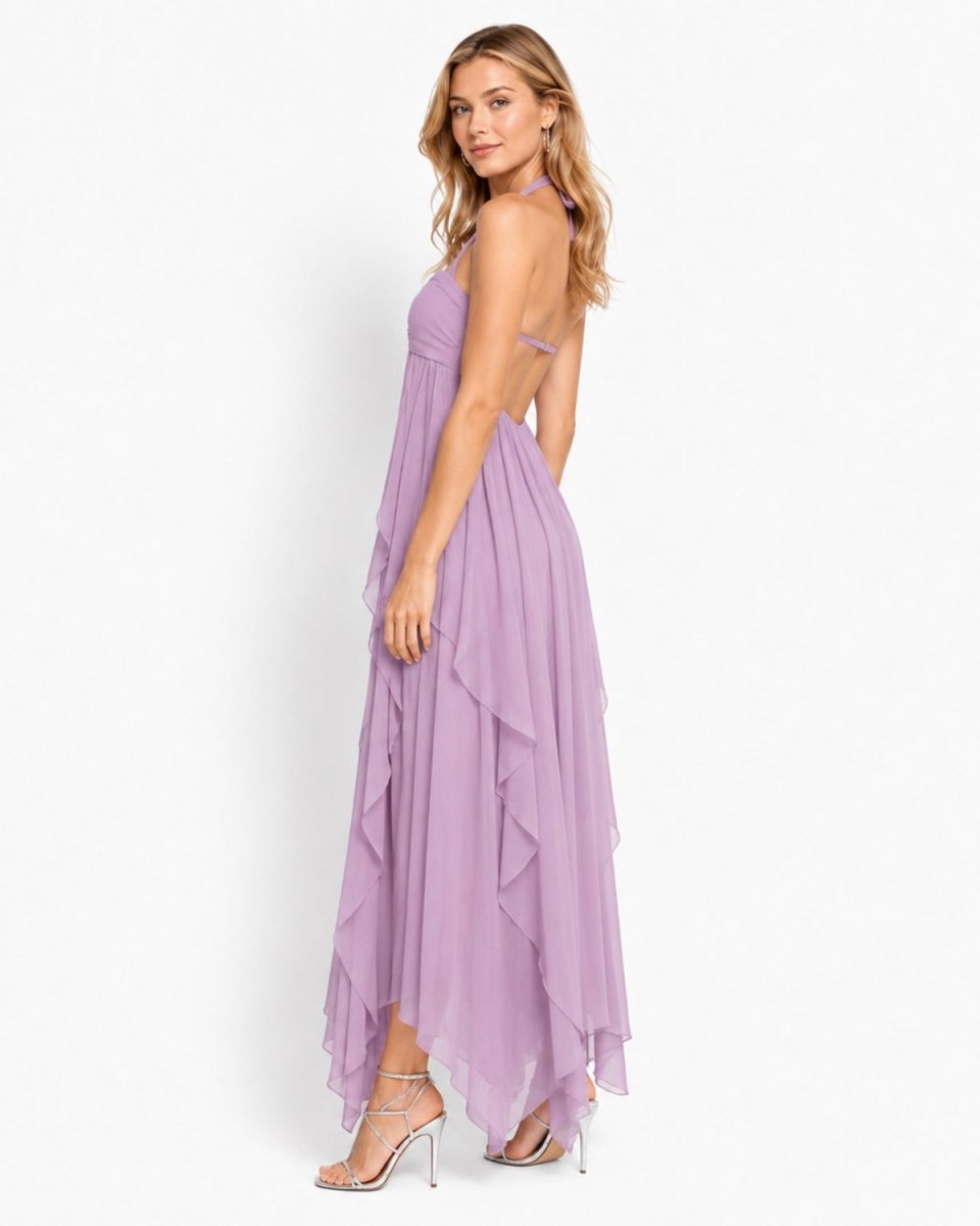 A woman modeling a lavender sleeveless maxi dress with a ruffled tiered skirt and side cutouts, shown from the back against a plain white studio background.
