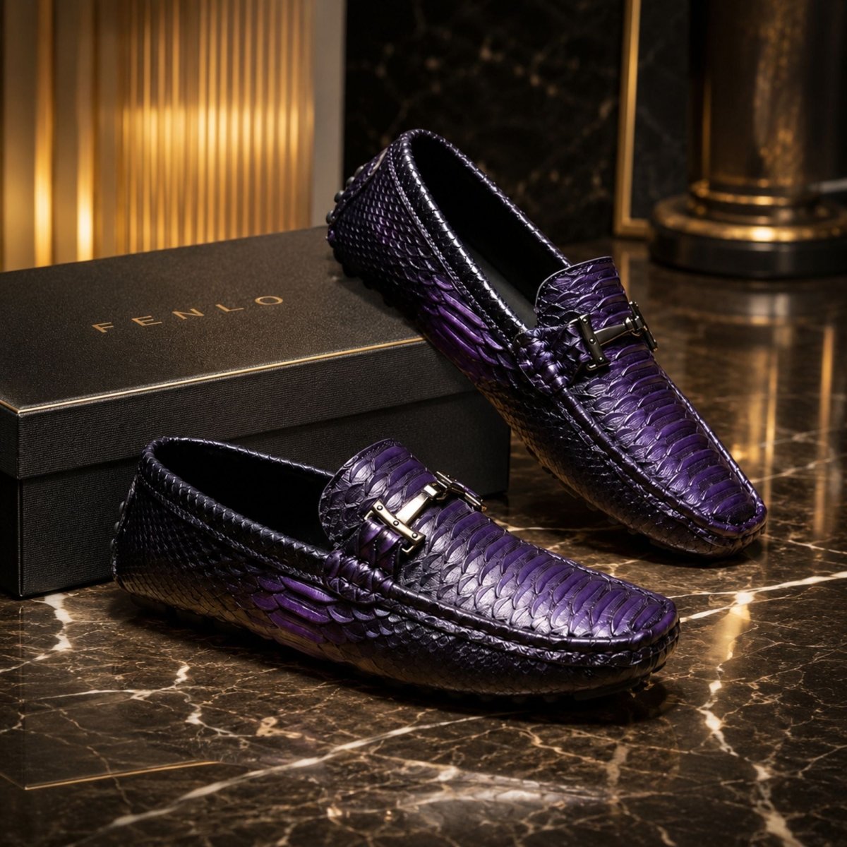 Two purple python-textured loafer shoes with silver-tone horsebit details, displayed on a black marble surface next to a black FENLO shoebox.
