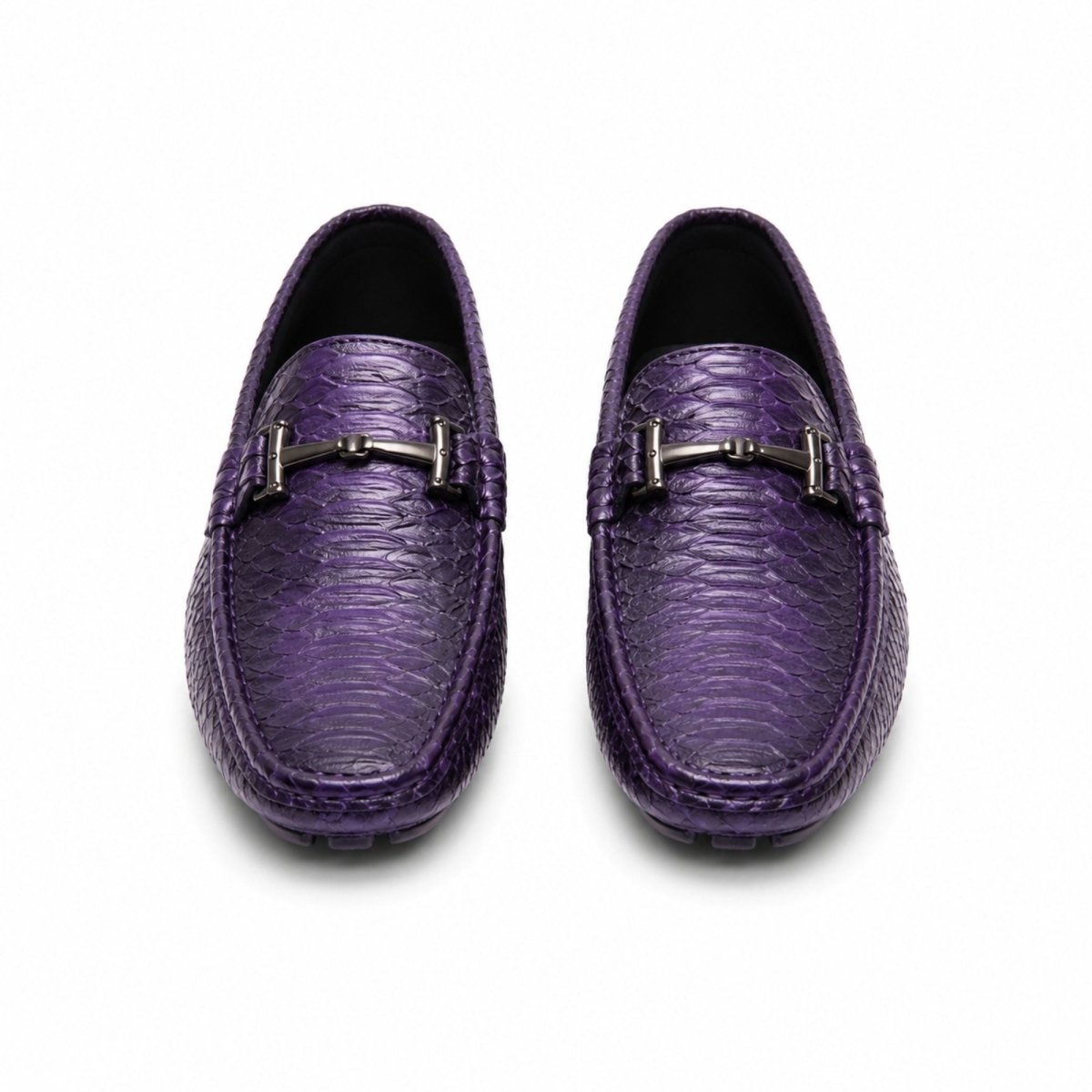 A pair of purple crocodile-embossed leather loafers with a silver horsebit detail on the vamp, shown from a top-down view on a white background.