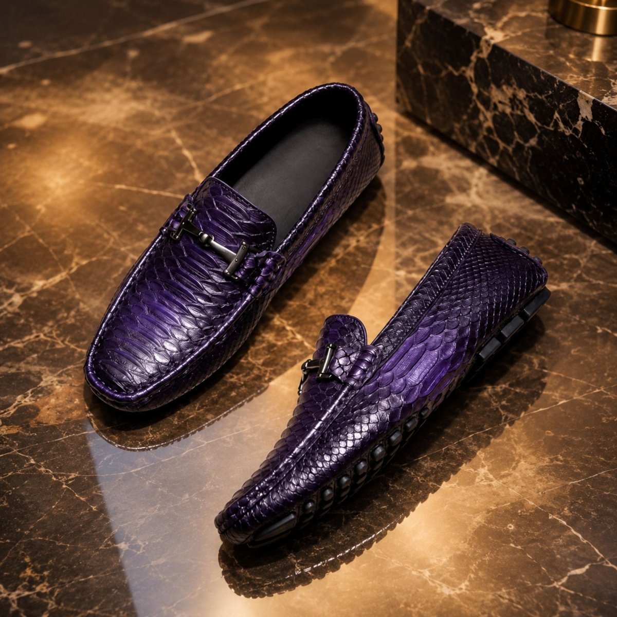 A pair of purple textured leather loafers with a crocodile pattern, displayed on a polished brown marble surface.