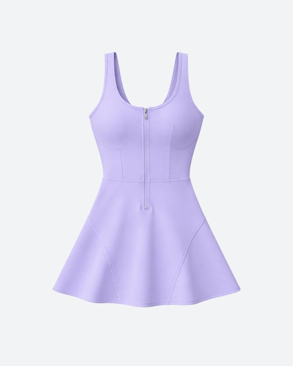  Flat lay studio shot of Kouvr lilac zip front tennis dress showing bodice seaming and half-zip hardware detail.