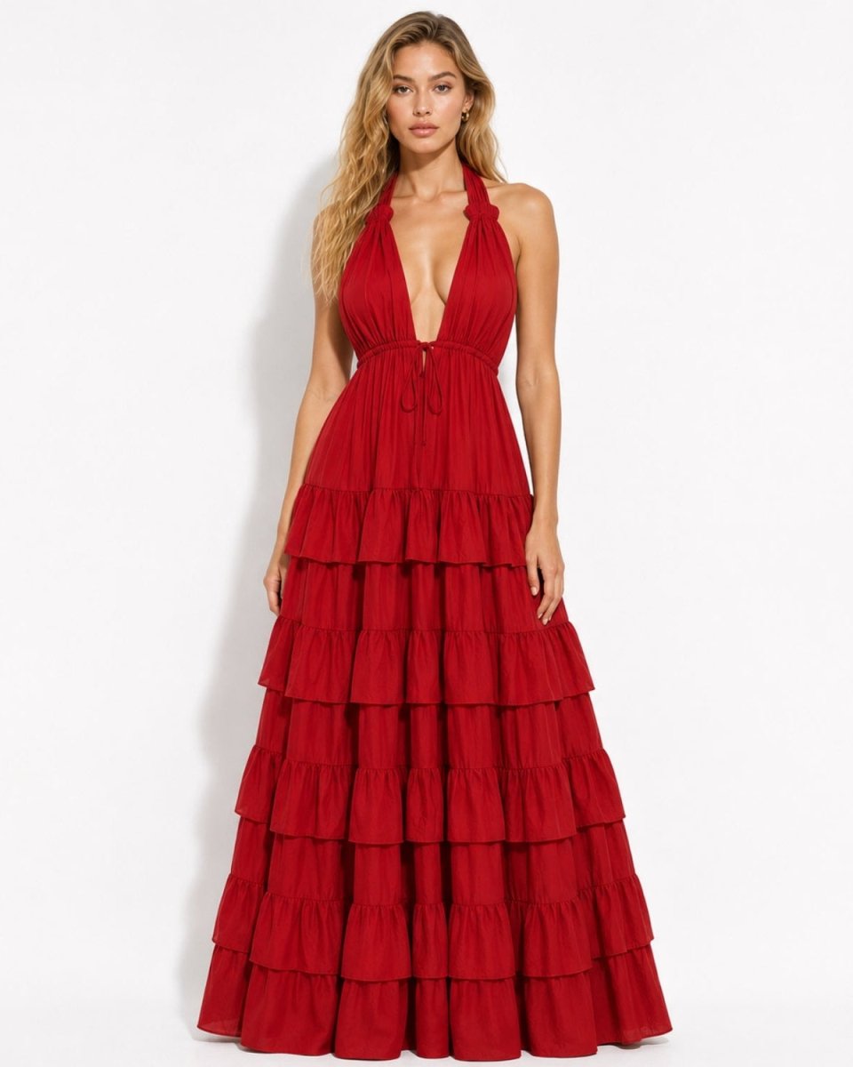 Front view of a woman wearing a red deep V-neck halter tiered maxi dress, featuring a long ruffled skirt and tie waist.