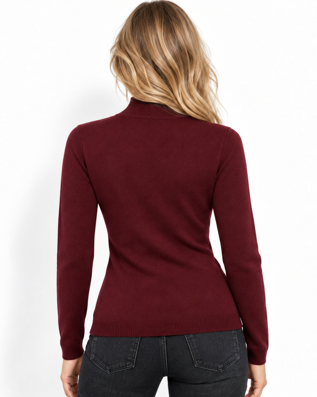 A woman viewed from the back wearing a fitted long-sleeve ribbed mock-neck sweater in burgundy, paired with dark gray jeans, against a plain white background.