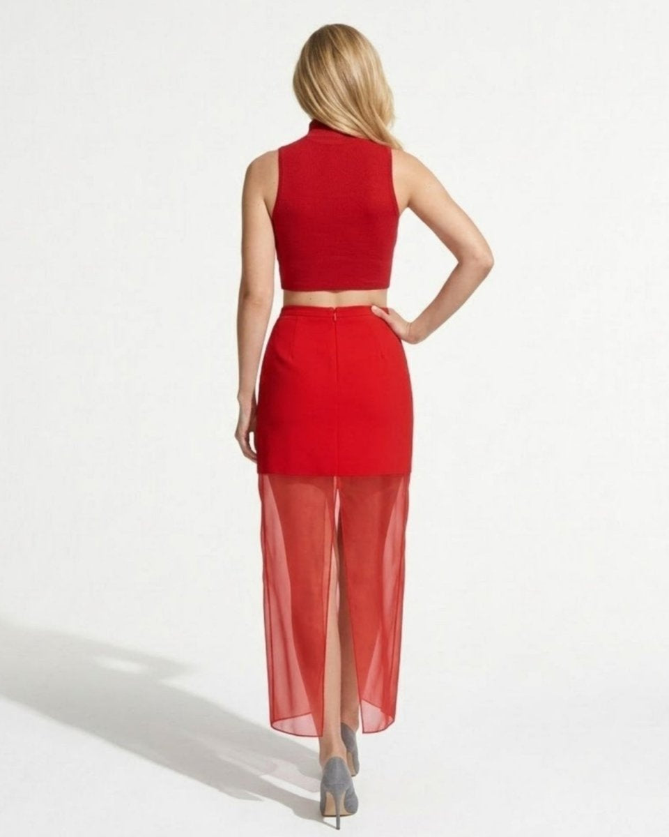 Back view of red layered skirt showing invisible zipper and back center slit on sheer fabric.
