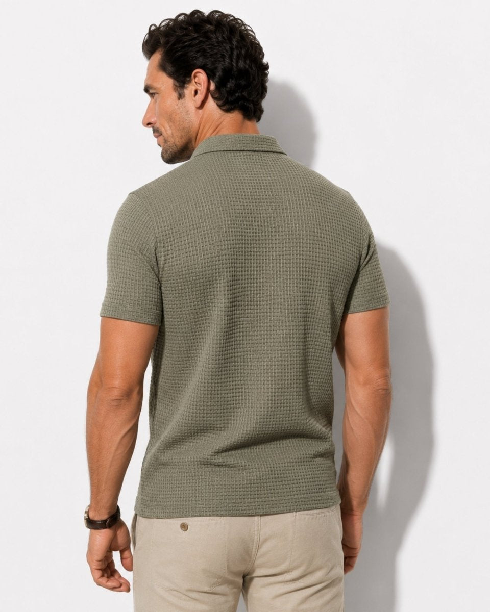 Man wearing a green textured polo shirt against a white background