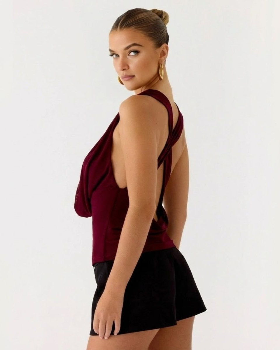 Back view of the Rhea top showing the open back design with criss-cross straps in a rich burgundy color.