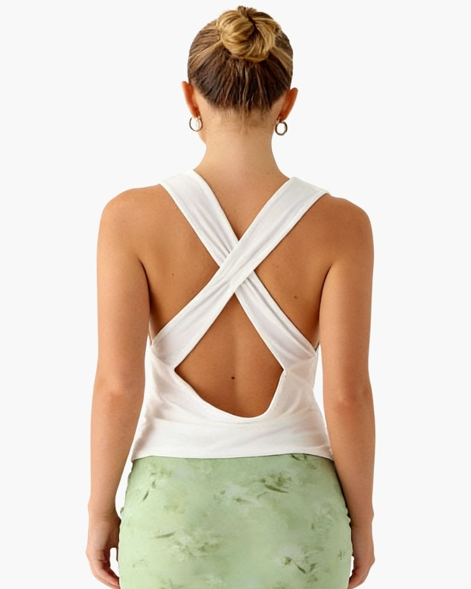 Back view of a model in the Rhea top, highlighting the open back with elegant criss-cross strap details.