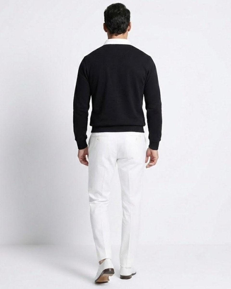 Back view of the Rhodes black knit polo sweater, showcasing the clean lines and white contrast collar.
