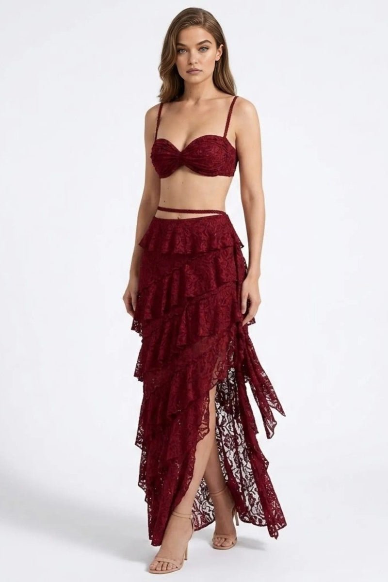Woman wearing a burgundy lace two-piece outfit on a white background
