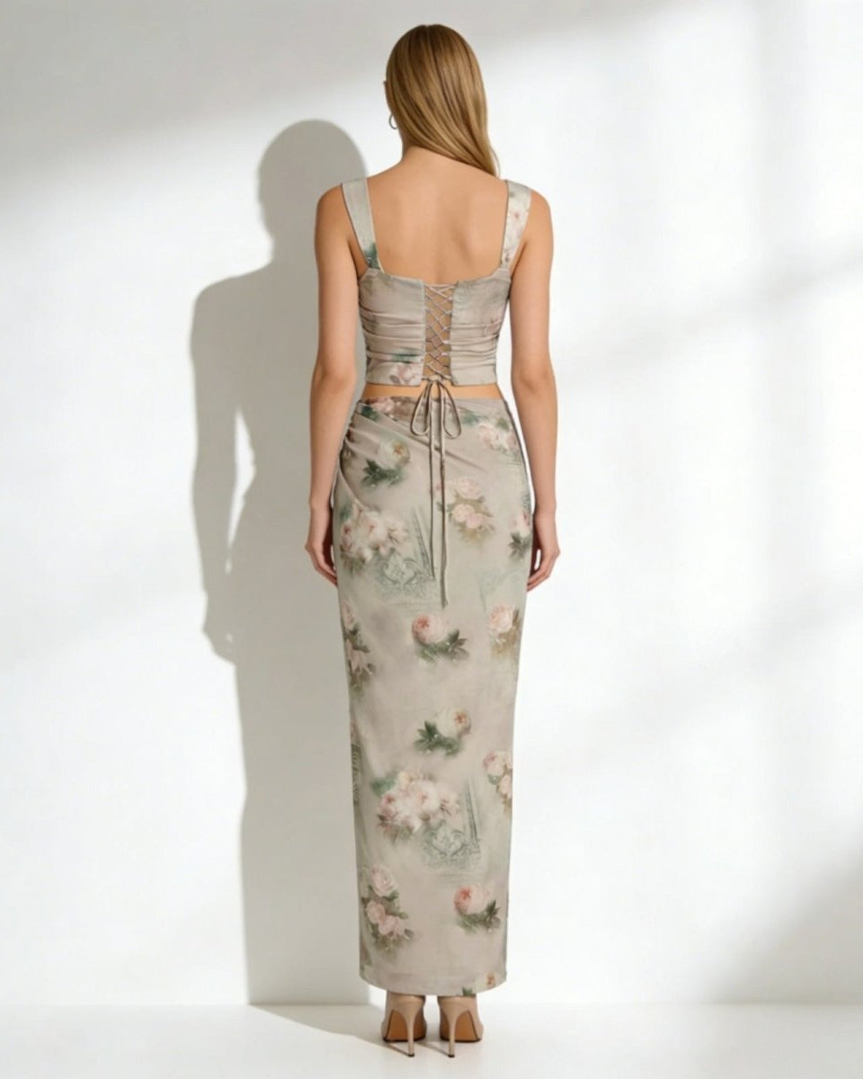 Back view of the Rona set, highlighting the adjustable lace-up detail on the corset top and the full length of the maxi skirt.