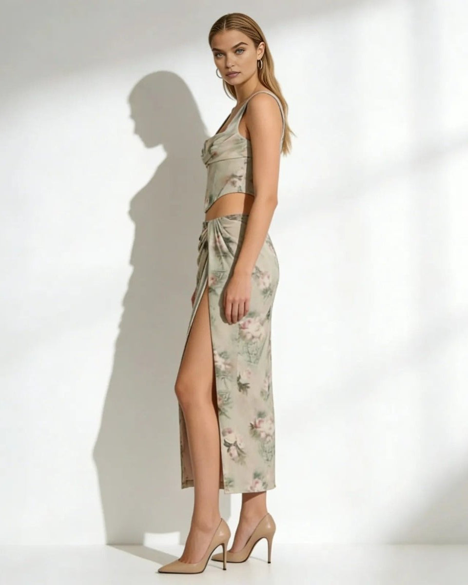 Side view of a model in the Rona floral skirt set, showcasing the elegant high leg slit and coordinated corset top.