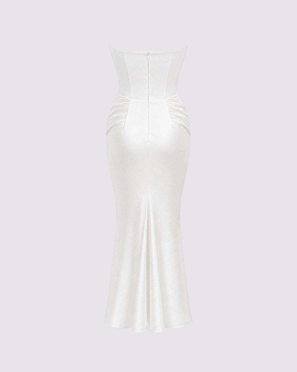 A strapless white satin midi dress with a structured corset-style bodice, ruched waist, and a fitted mermaid silhouette, shown against a solid light gray background.