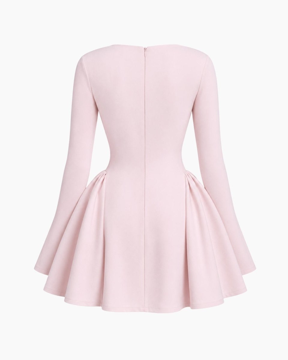 A light pink long-sleeve dress shown from the back, featuring a structured bodice, a flared skirt, and a central back zipper, set against a plain white background.