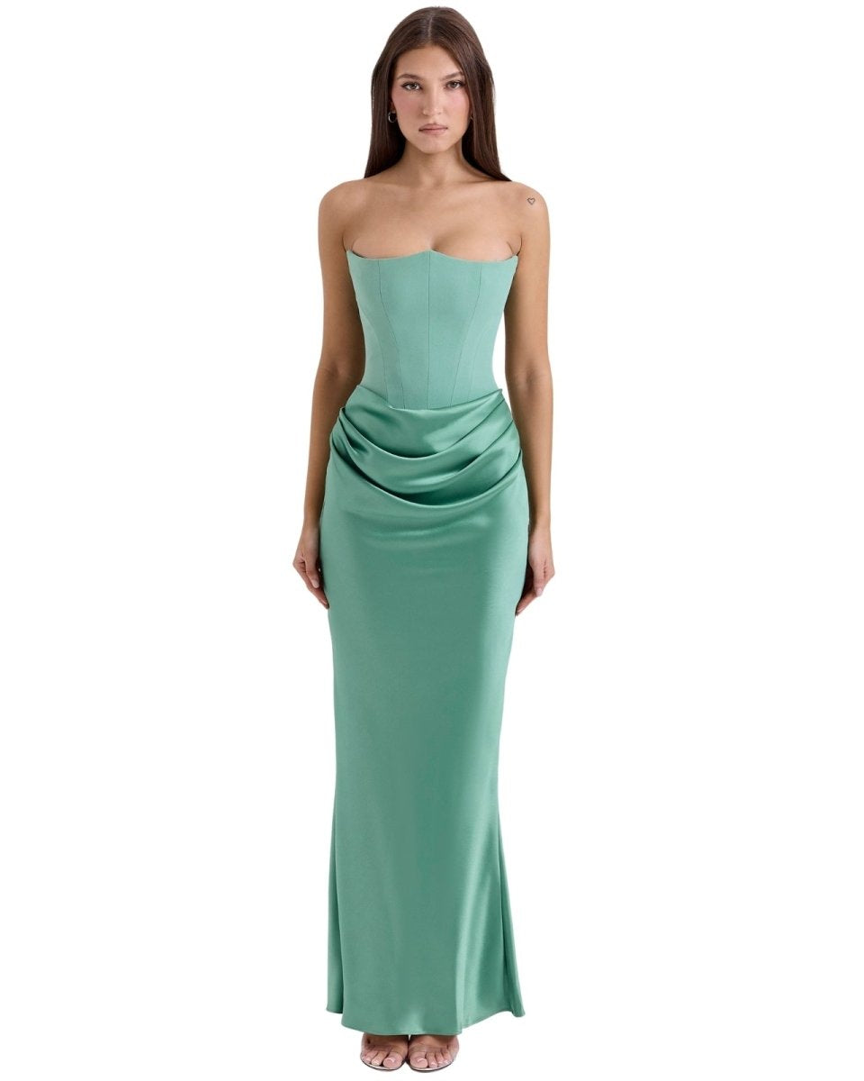 Woman wearing a strapless green gown on a white background