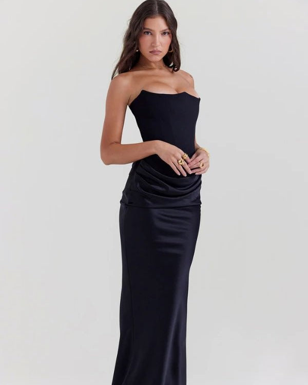 Woman wearing a black strapless gown on a white background