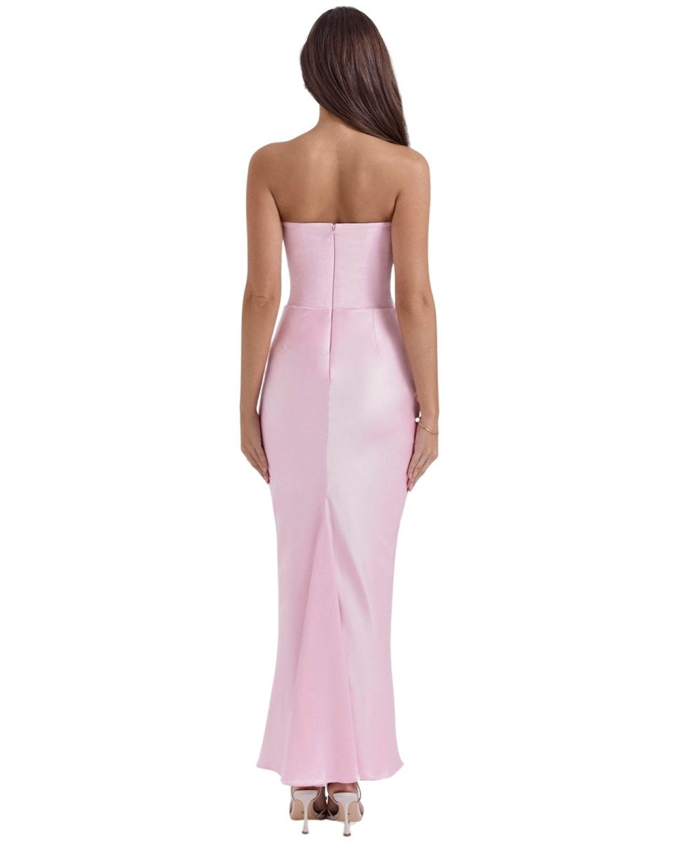 Woman wearing a strapless pink evening gown on a white background