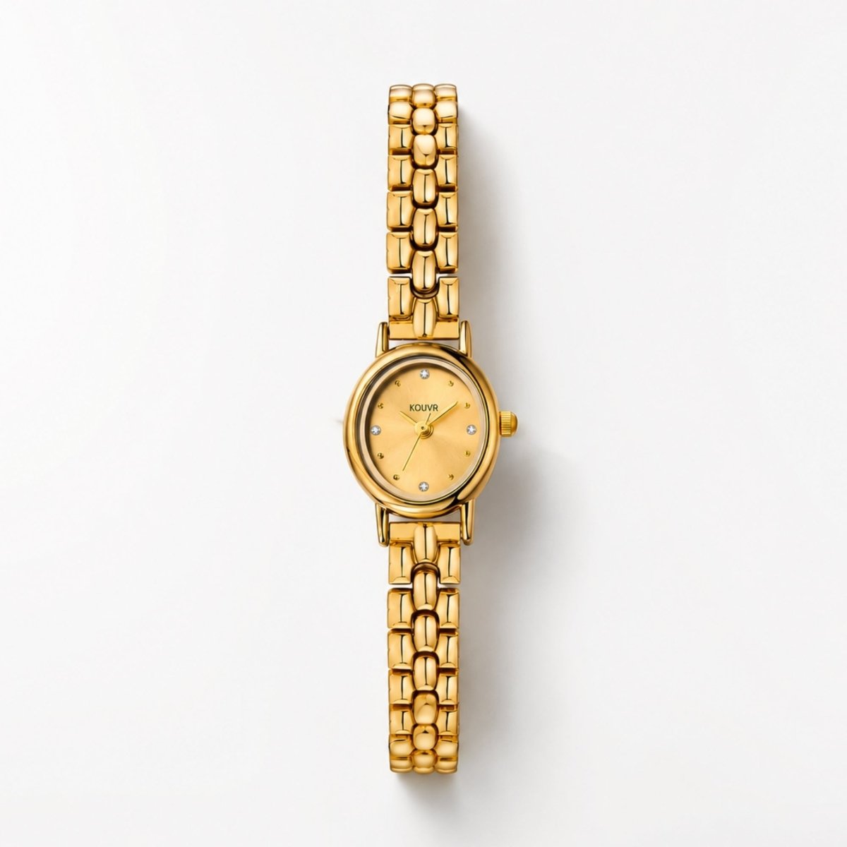Flat lay of the Kouvr women's gold stainless steel watch showing the small round face, champagne sunray dial, and crystal markers.