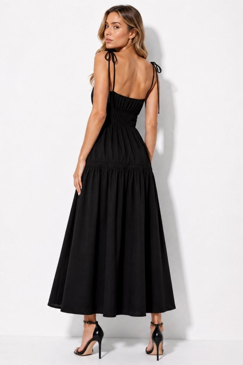 Back view of black elevated maxi dress showcasing delicate tie shoulder straps
