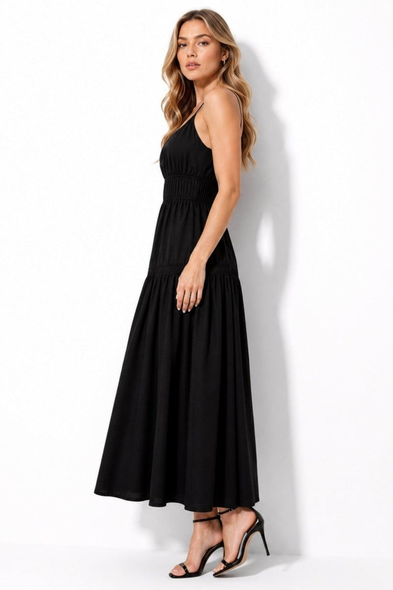 Side view of black luxury resort wear maxi dress with elegant flowy skirt
