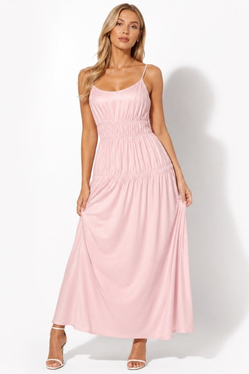 Woman modeling a light pink smocked waist tiered maxi dress with scoop neckline