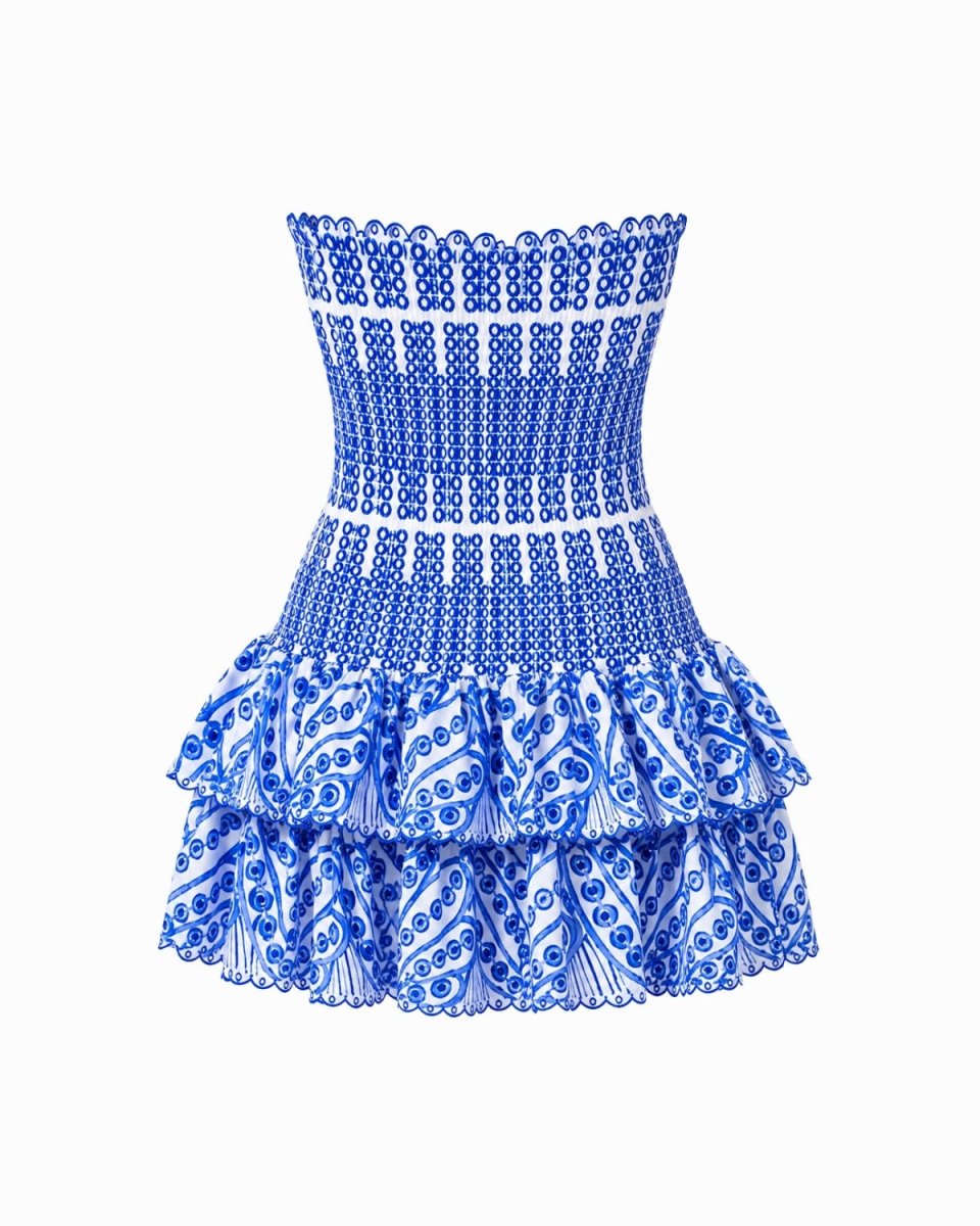 A strapless mini dress featuring a smocked blue and white patterned bodice and a tiered ruffled skirt, shown against a plain white background.