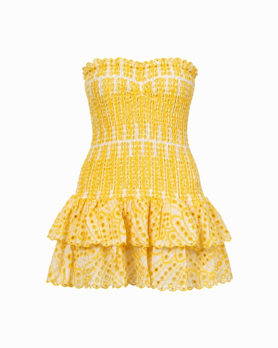 A yellow and white patterned strapless smocked dress with a ruffled neckline and tiered ruffle skirt, shown against a plain white background.