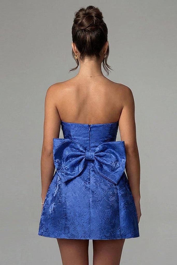 Back view of Kouvr dark blue party dress highlighting the oversized statement bow and invisible zipper detail.