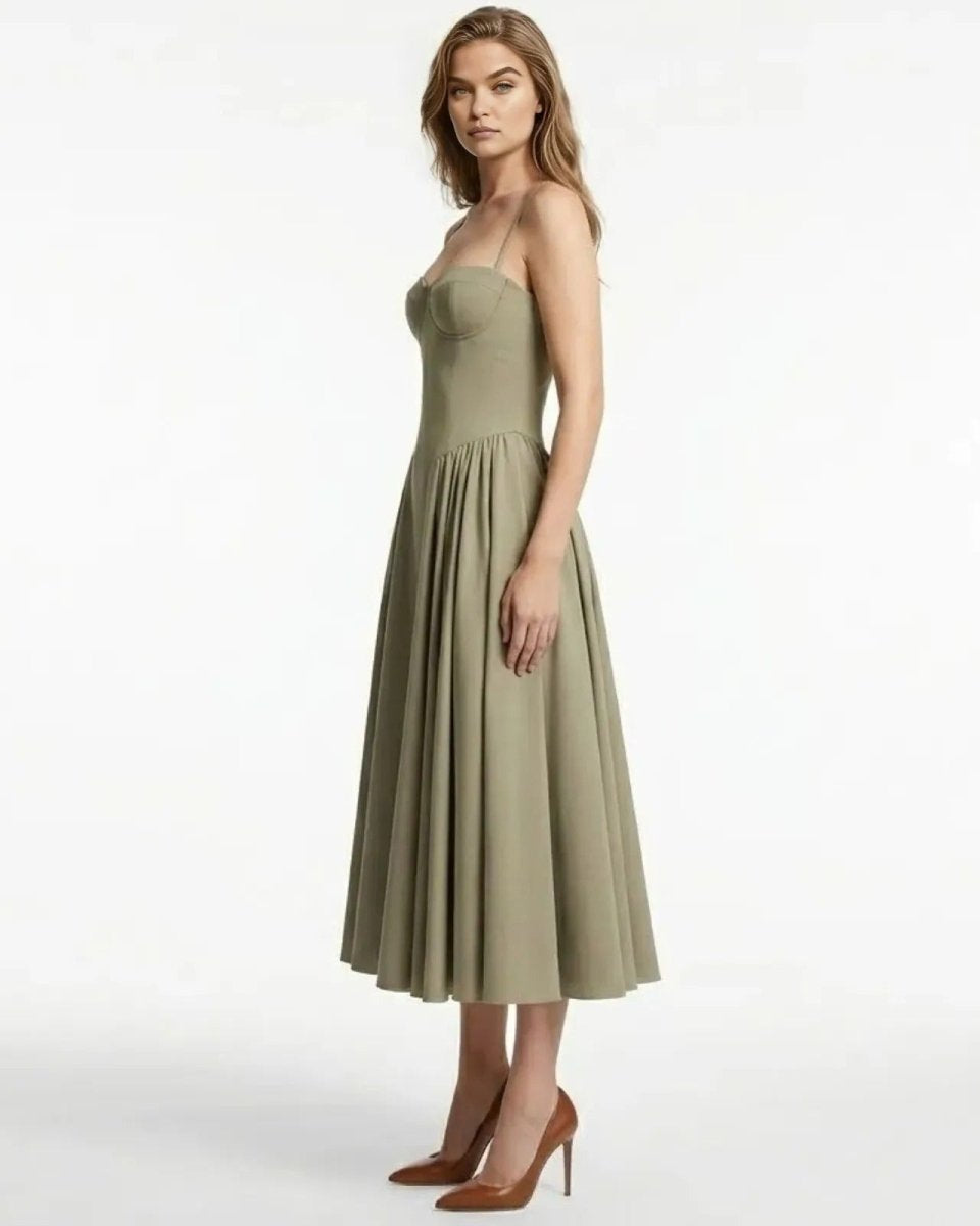 Side view of the taupe structured midi dress, highlighting the fit of the corset bodice and the volume of the pleated skirt.