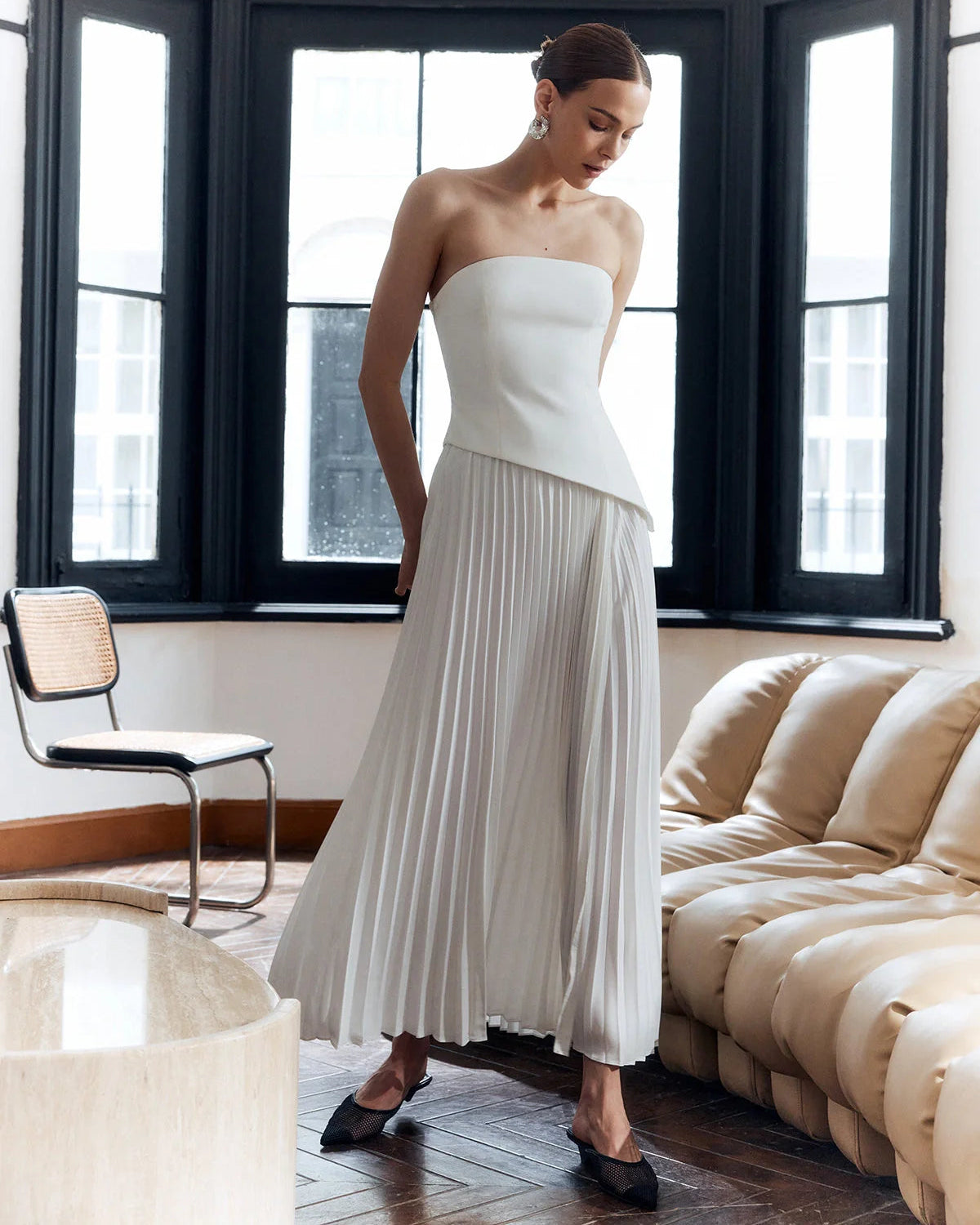 architectural," "sculptural," "asymmetrical," "bonded crepe," and "sunray pleats