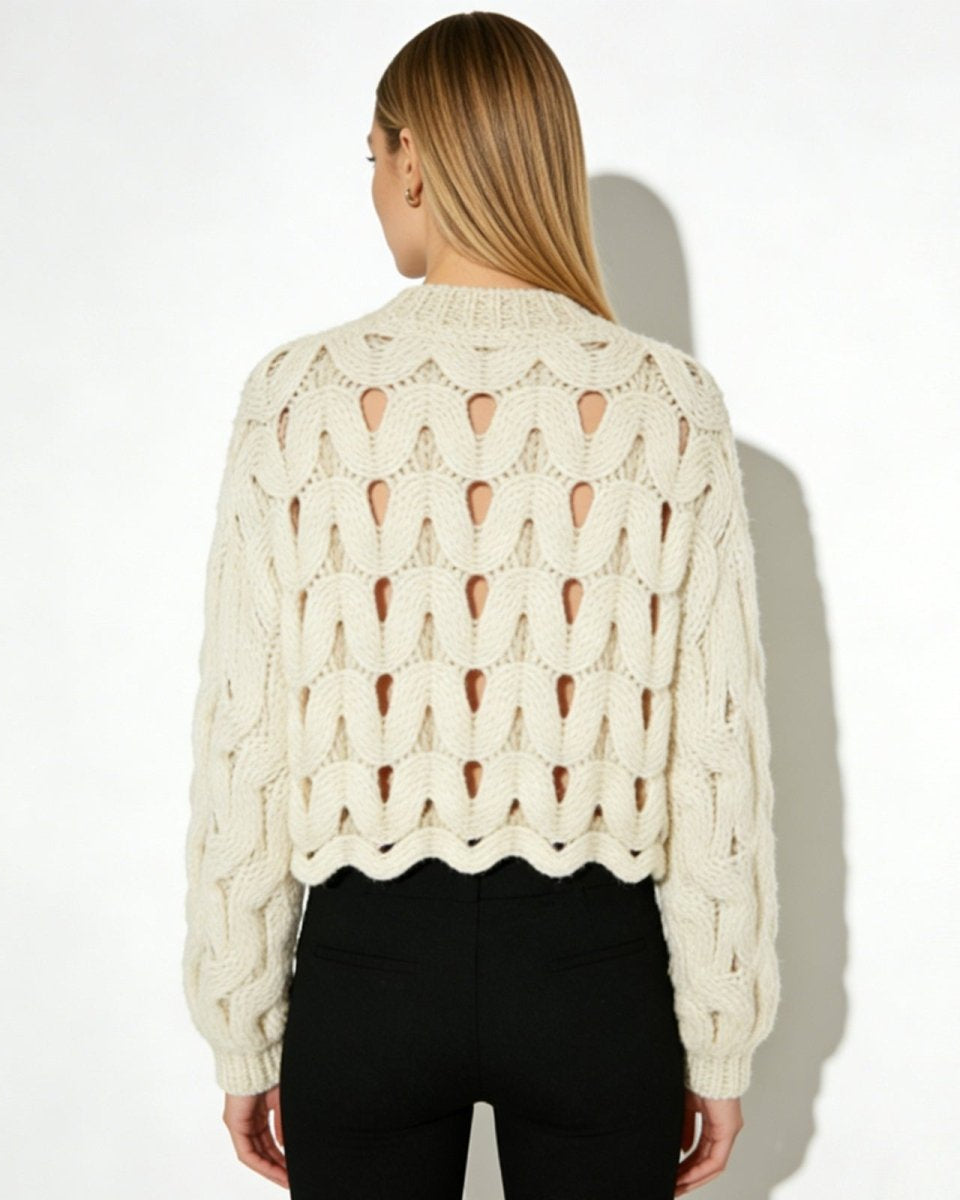 Back view of the Vanice open-knit sweater showcasing the continuous wave cutout pattern.