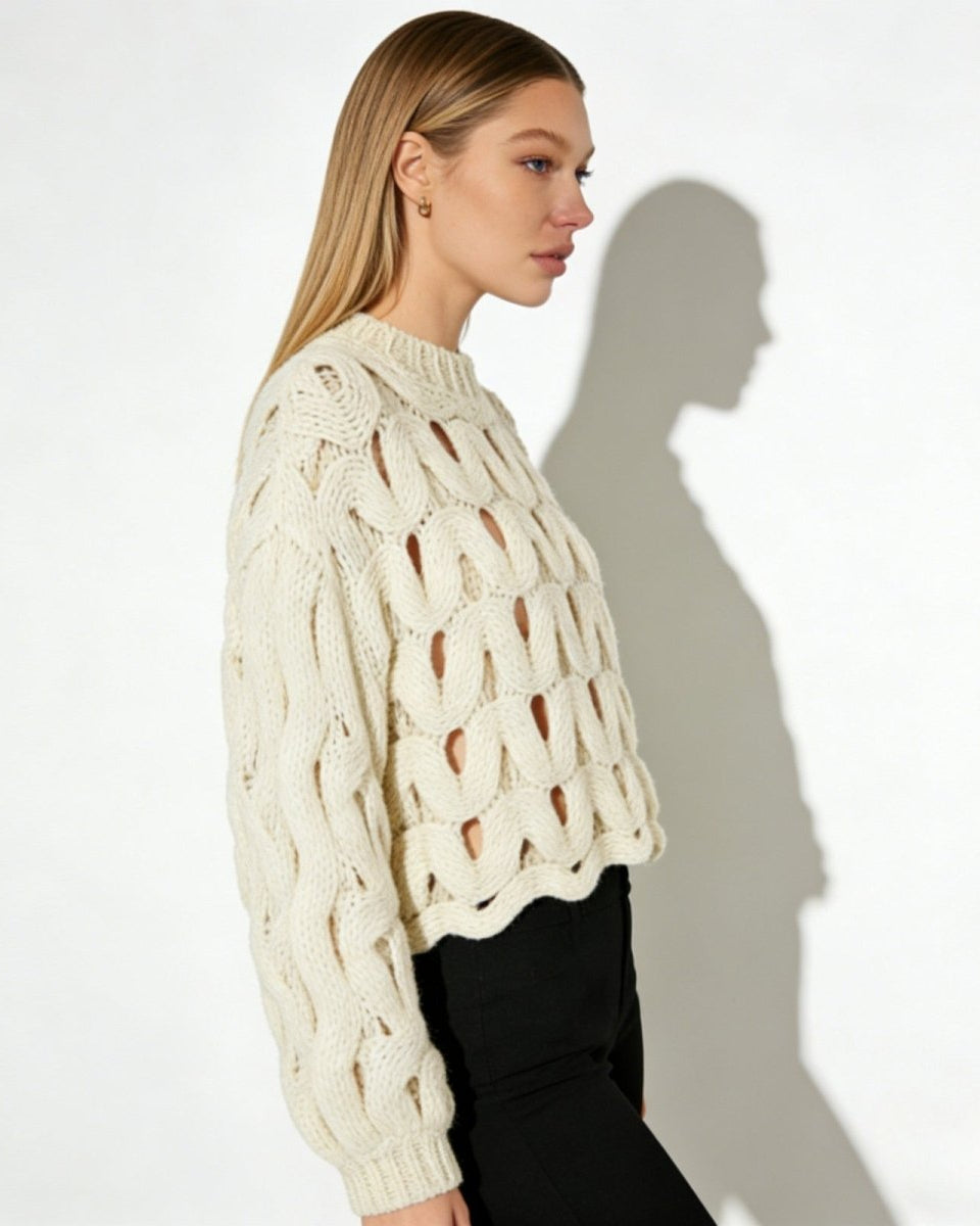 Side view of a model in the Vanice sweater, highlighting the balloon sleeve silhouette and cropped length.