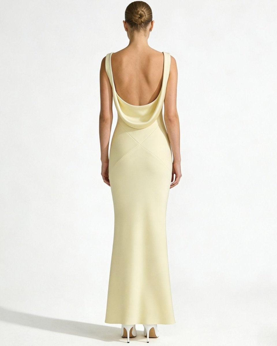 Back view of the Vickie Gown, highlighting the dramatic low draped backless design and X-seam detail of the ivory satin formal dress.