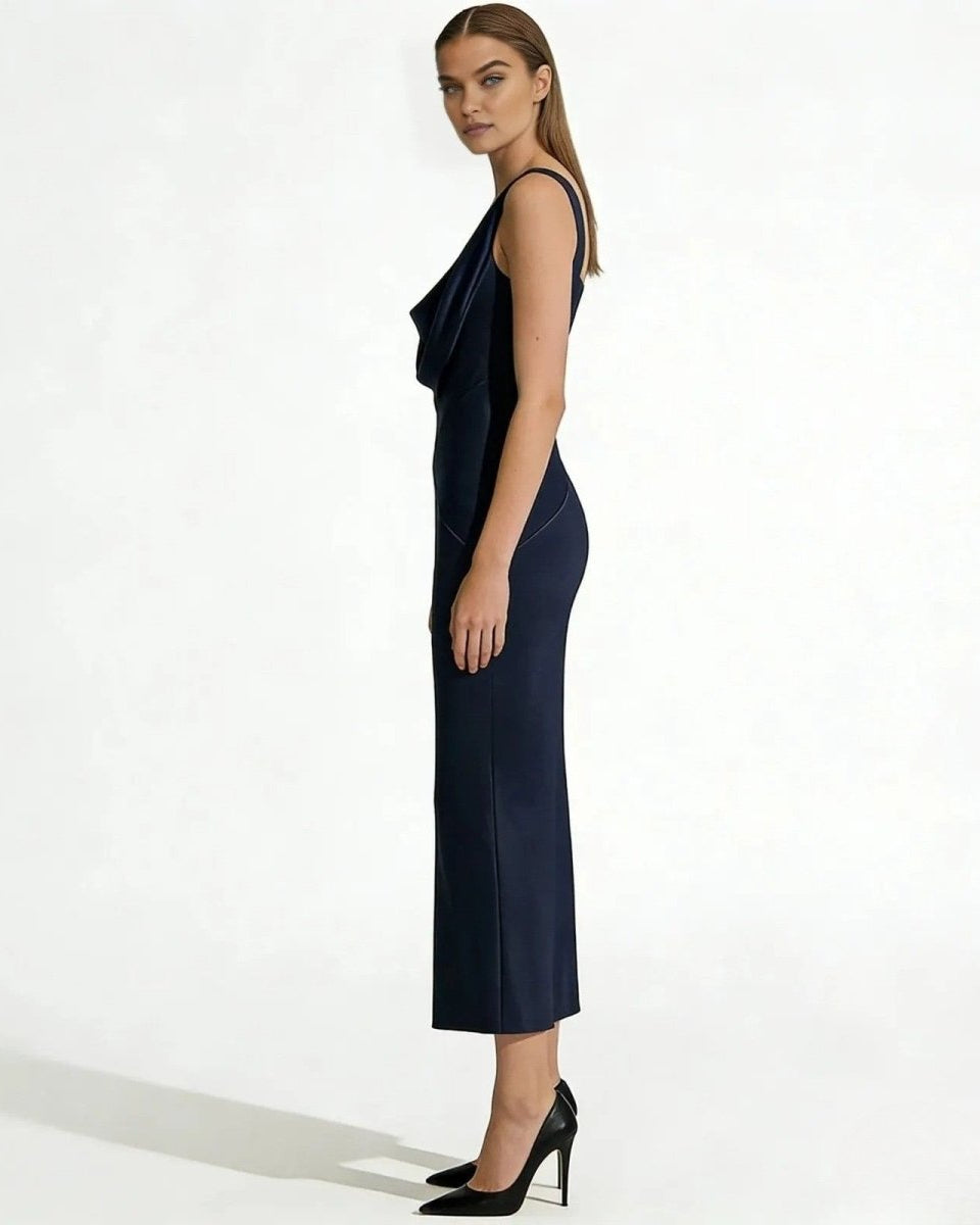 Side profile of a model in the Vickie Gown in navy, highlighting the bias cut and form-skimming satin fabric.