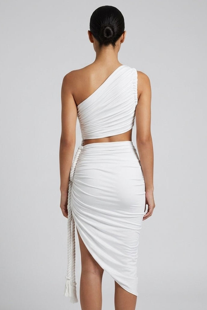 Back view of the Fenlo form white asymmetrical cutout dress showing the one shoulder ruched back and side rope detail.